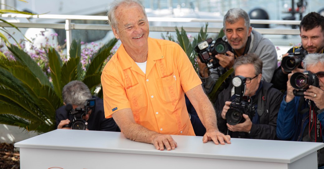 Bill Murray surrounded by photographers at Cannes Film Festival.