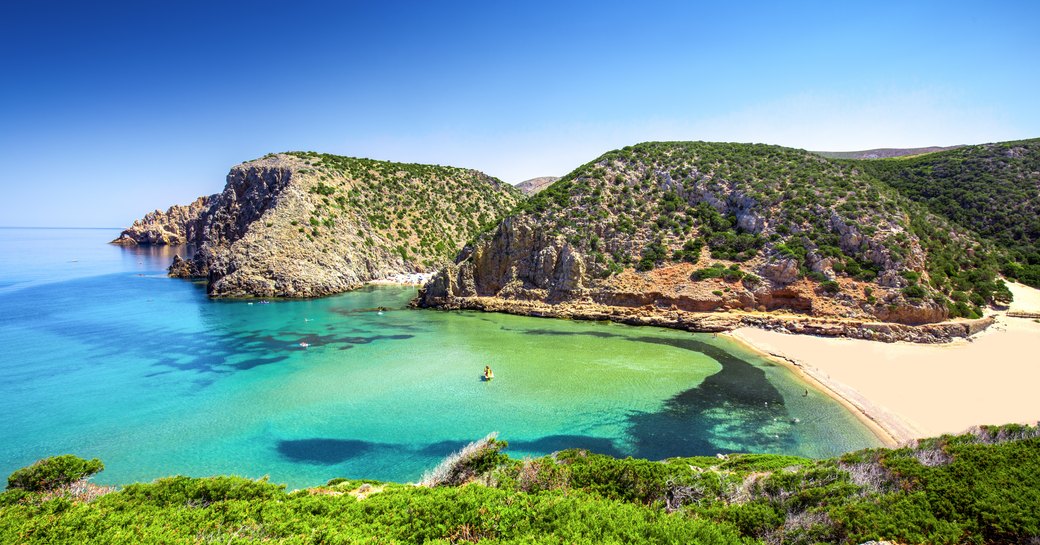 Blue water in secluded bay in Sardinia