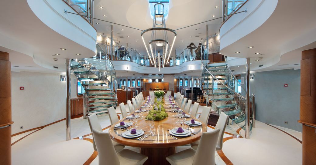 Expansive dining table set up onboard luxury charter yacht SHERAKHAN