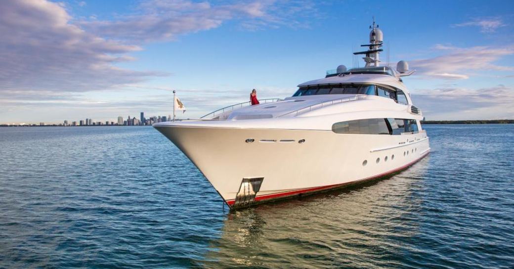 Superyacht USHER with a charter guest relaxing on her bow