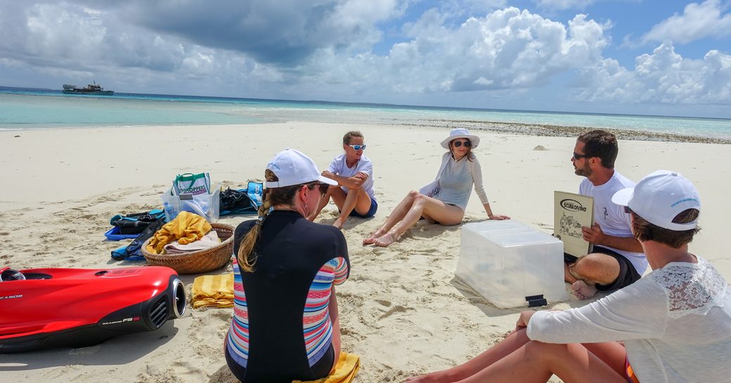 Guests at the Thanda island resort in the Indian Ocean getting instructions before scuba diving