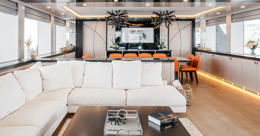 Main salon lounge seating onboard charter yacht HEEUS