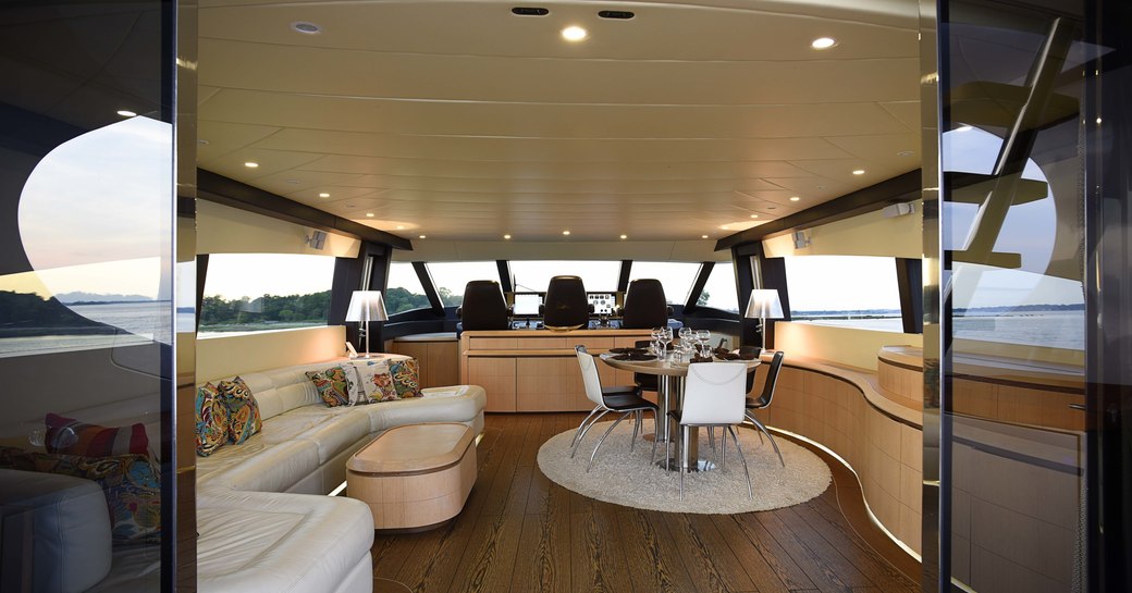 lounge and dining table in the light and airy main salon on charter yacht Silver Mama