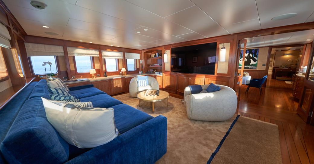 Interior seating area with large wall-mounted TV onboard charter yacht ASTERIA