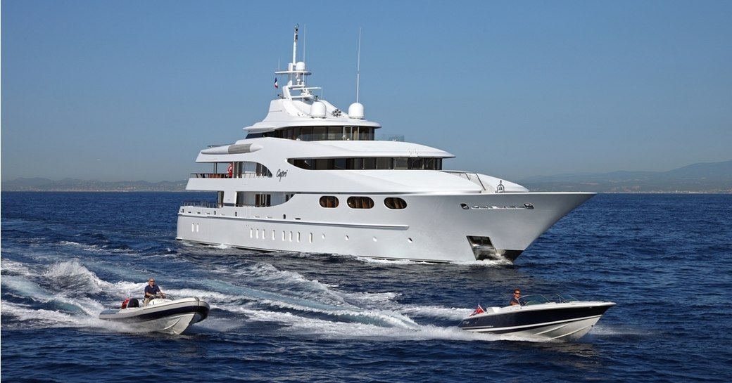 motor yacht CAPRI cruises on a luxury yacht charter alongside two tenders