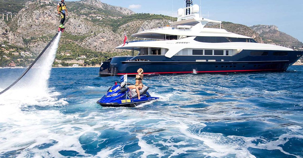 superyacht MISCHIEF docked on charter in the Caribbean as charter guests play on jet ski and jet pack