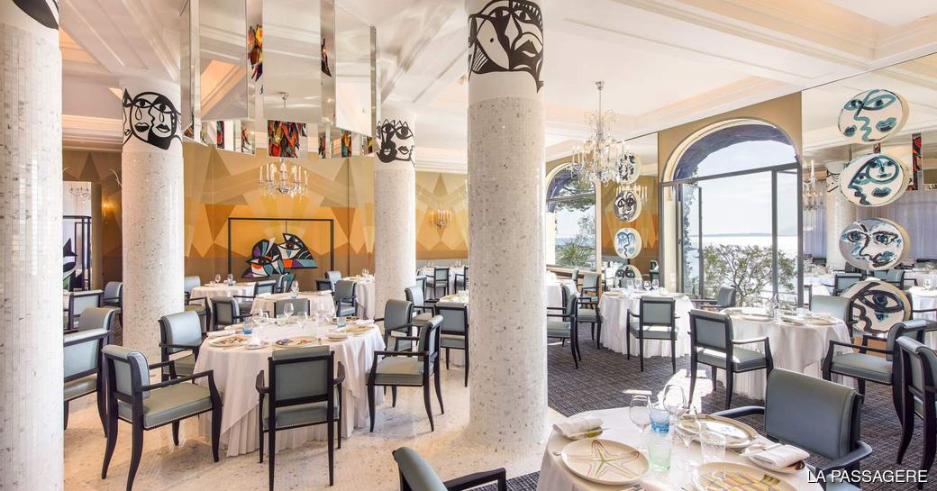 Tables set for evening service at La Passagere, Antibes
