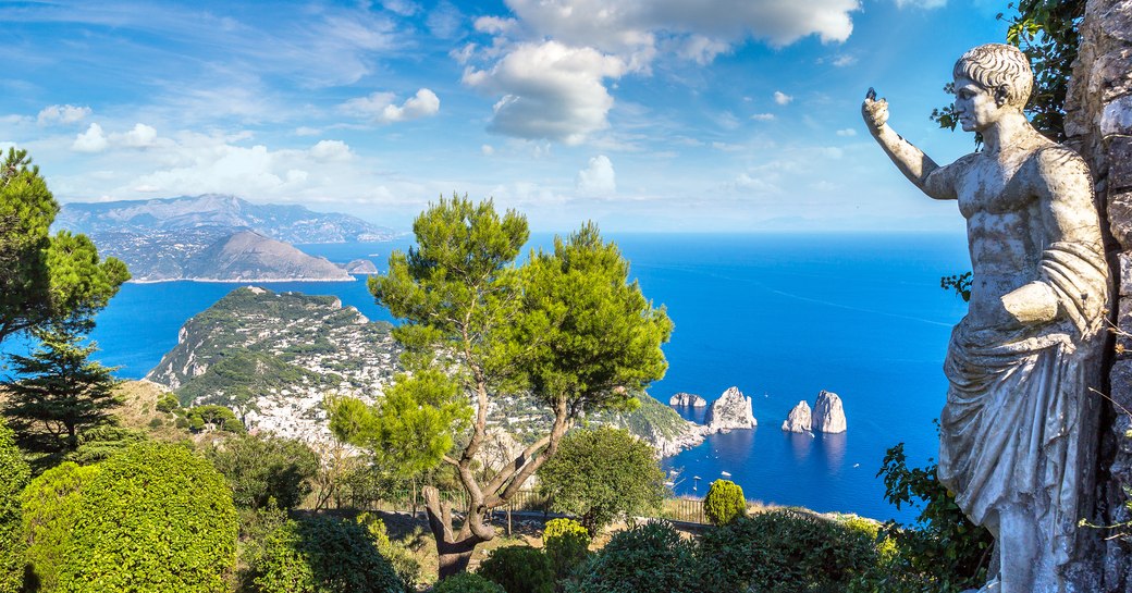 statue on the coast of capri island, overlooking the water