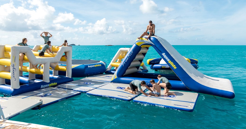 Charter yacht TITANIA's stand-out selection of water toys, including an inflatable water park, slides and trampoline