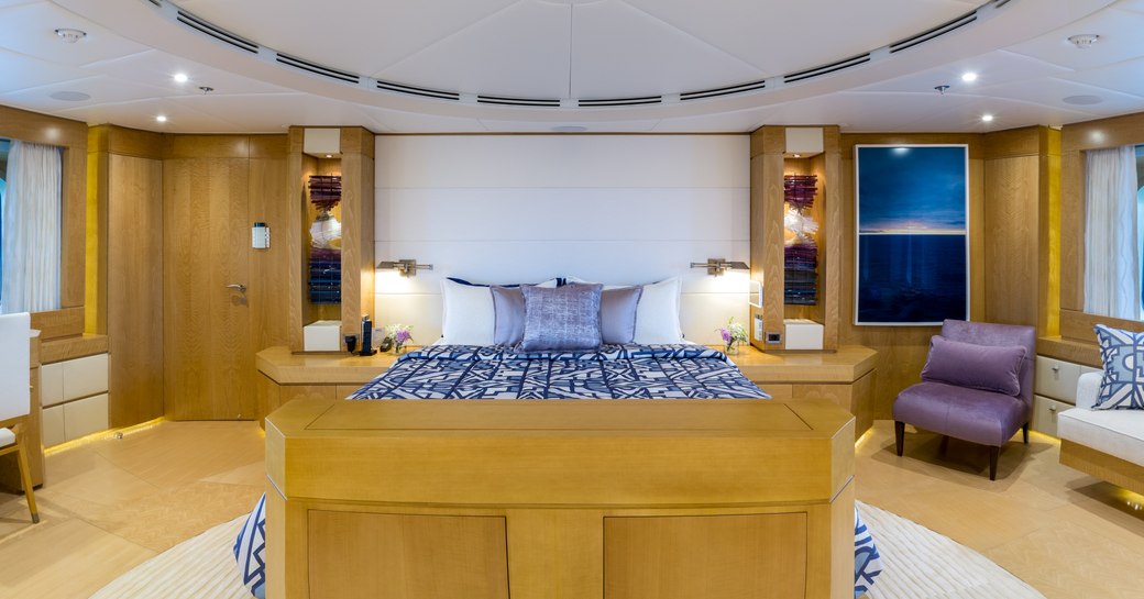 Large cabin on Superyacht BACA with bed and chairs either side