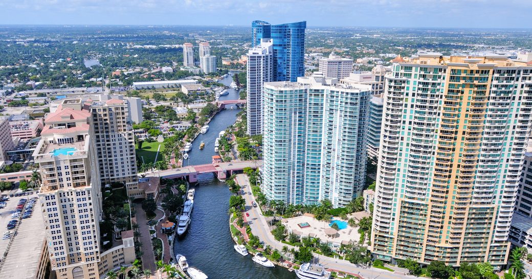 Overview of Fort Lauderdale, elevated view of causeway surrounded by towering hotels and cosmopolitan backdrop.