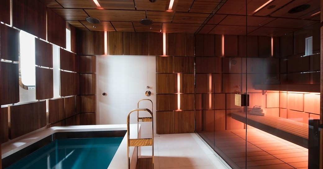 The plunge pool and sauna separated by a glass screen on motor yacht CLOUDBREAK