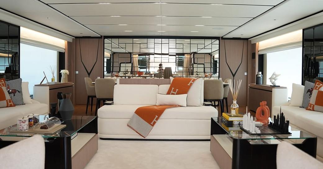 Main salon with white seating onboard charter yacht GEULUNEL