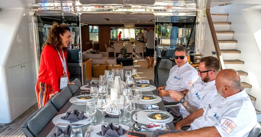 Chef competition at CROYA Charter Show with three judges tasting dishes