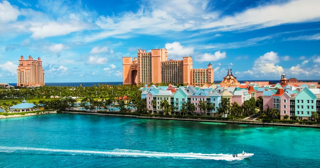 a guest hops on board their tender while ona  luxury yacht charter vacation to the Bahamas and cruises down some crystal clear water