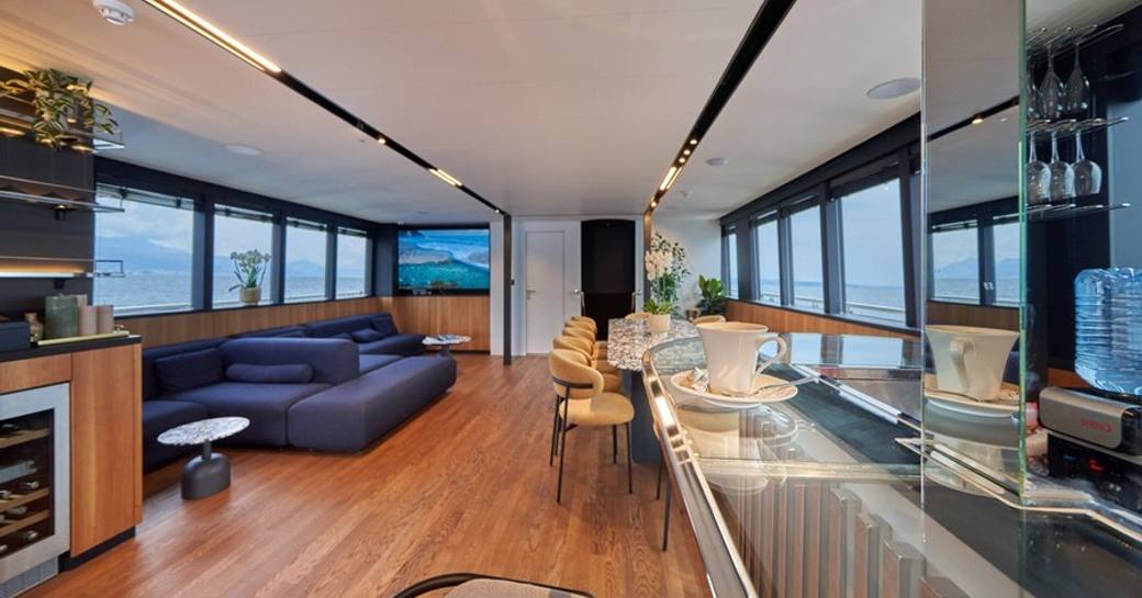 Main salon with galley and lounge area onboard yacht rental MARALLURE