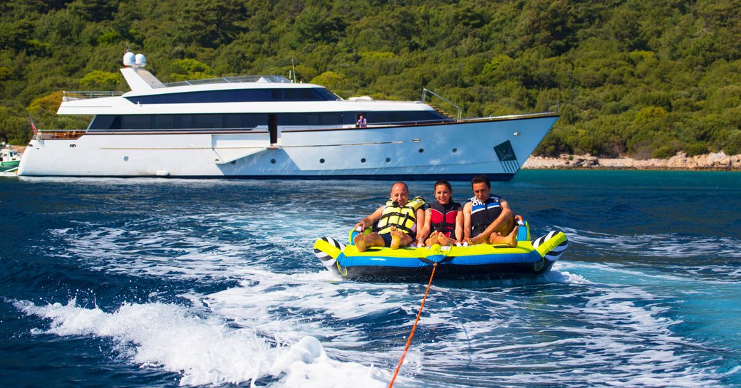 charter guests enjoy water toys on their vacation