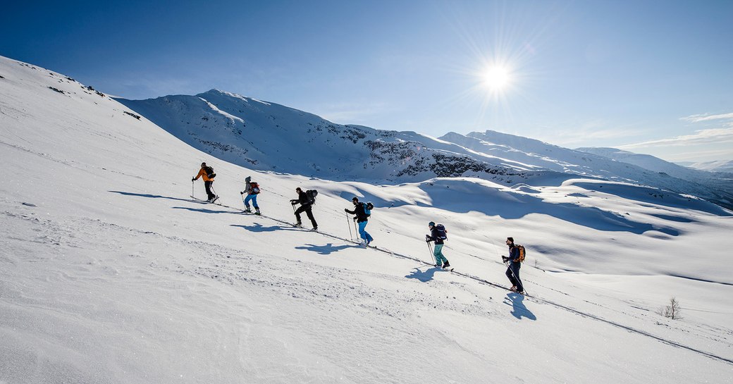 charter guests aboard superyacht FIREBIRD off-piste skiing 