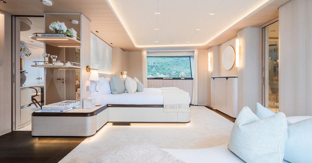 Overview of the master cabin with central berth and large window onboard charter yacht M