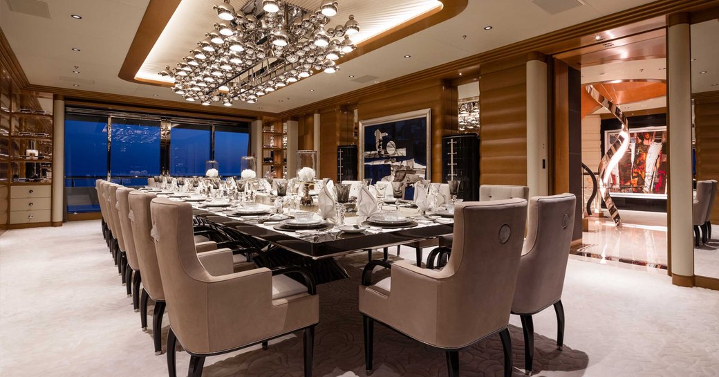 formal dining table and art installation on board charter superyacht lana