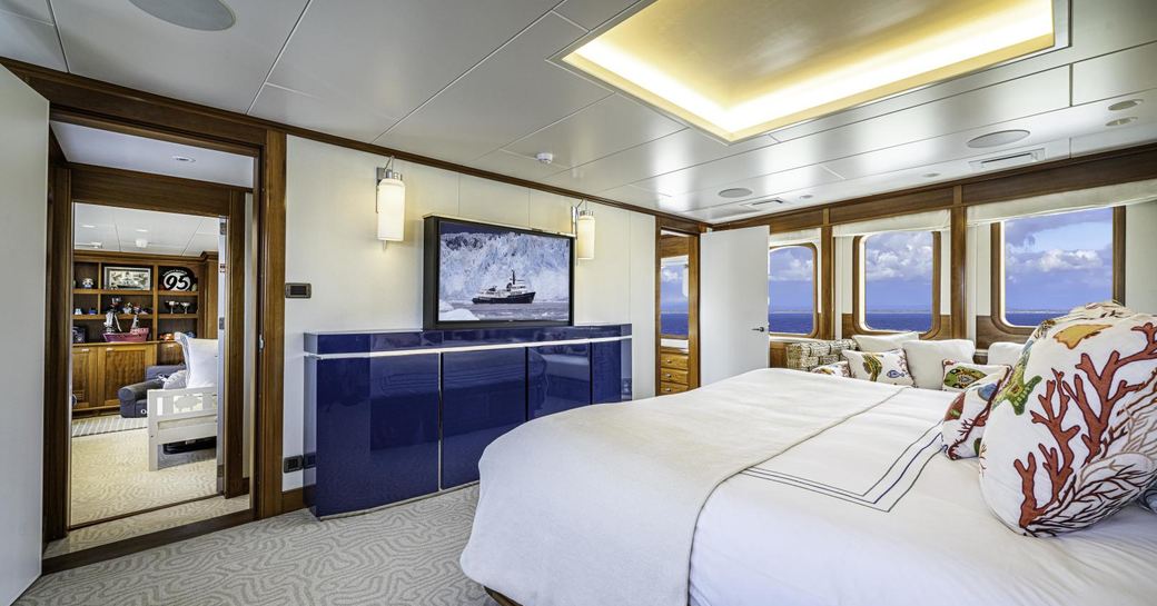 Master cabin onboard charter yacht ASTERIA with central berth and large windows aft