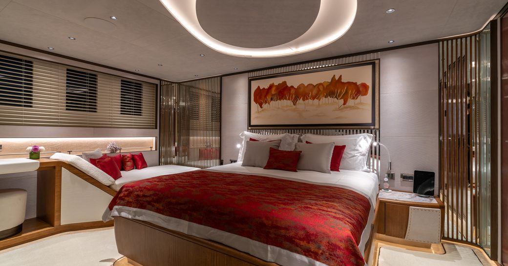 Guest cabin onboard charter yacht ETERNAL SPARK with central berth and seating to port side