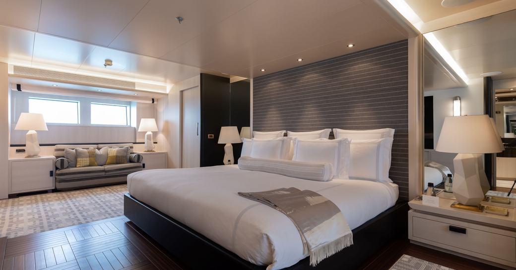 Master cabin onboard charter yacht ETERNITY with central berth and seating under window