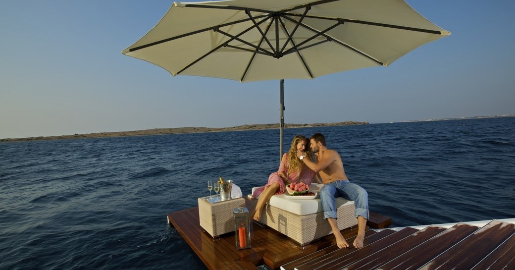 Couple relaxing on the beach club of O'MEGA