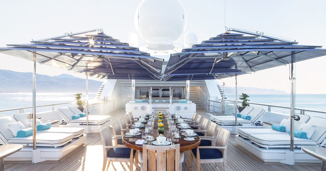 Superyacht TITANIA's upper deck, with al fresco dining, sun pads and spa pool