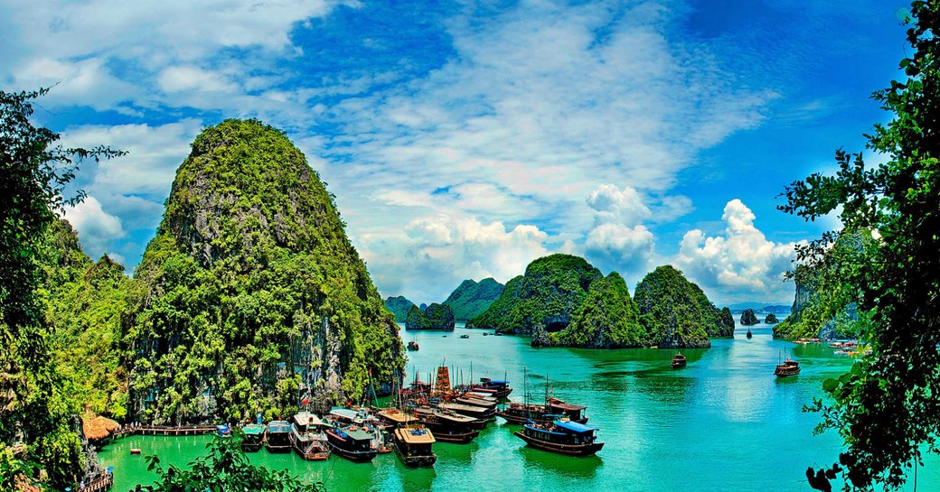 A collection of small wooden boats assembled in the waters of Thailand