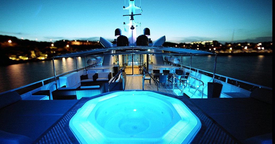 nighttime shot of jacuzzi pool on sundeck of luxury charter magna grecia