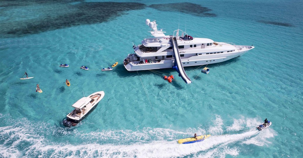 crewed charter yacht At last anchored in the Caribbean with her guests using all of her waters toys on the shallow and crystalline waters