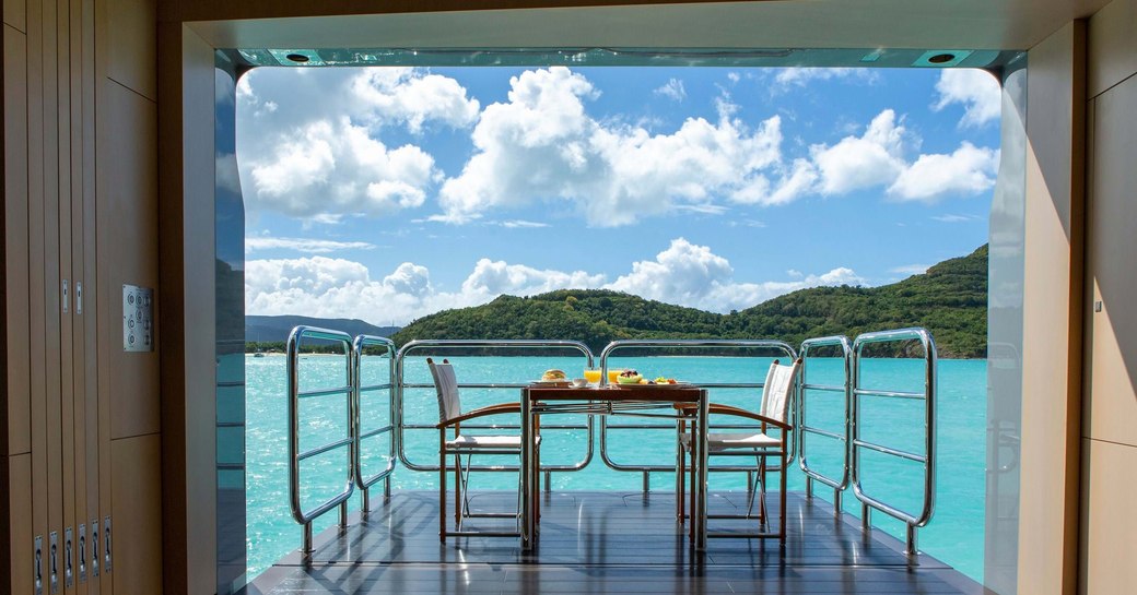 unfolding balcony on superyacht ramble on rose, with tropical caribbean backdrop