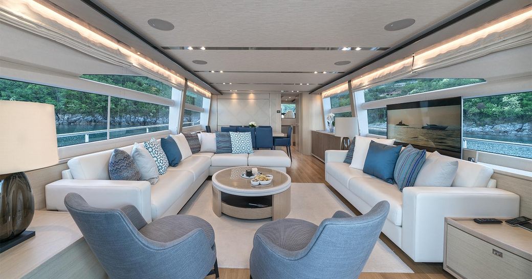 Overview of main salon with extensive seating onboard charter yacht LARIMAR II