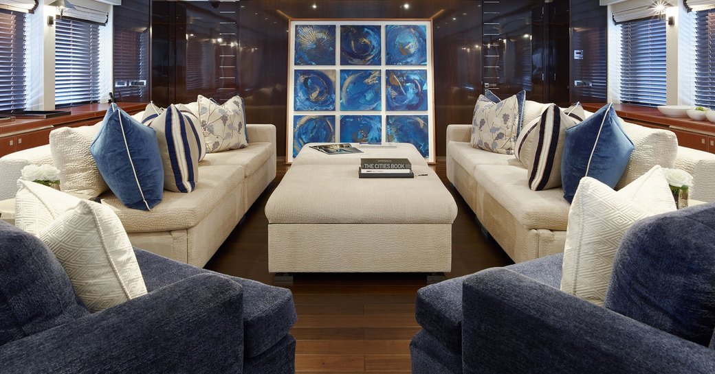 cream sofas and navy armchairs in the main salon aboard motor yacht ROCKET 