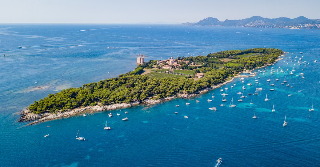 Aerial drone shot view of yachts between Ile Sainte Marguerite and Ile Saint Honorat in mediterranean sea