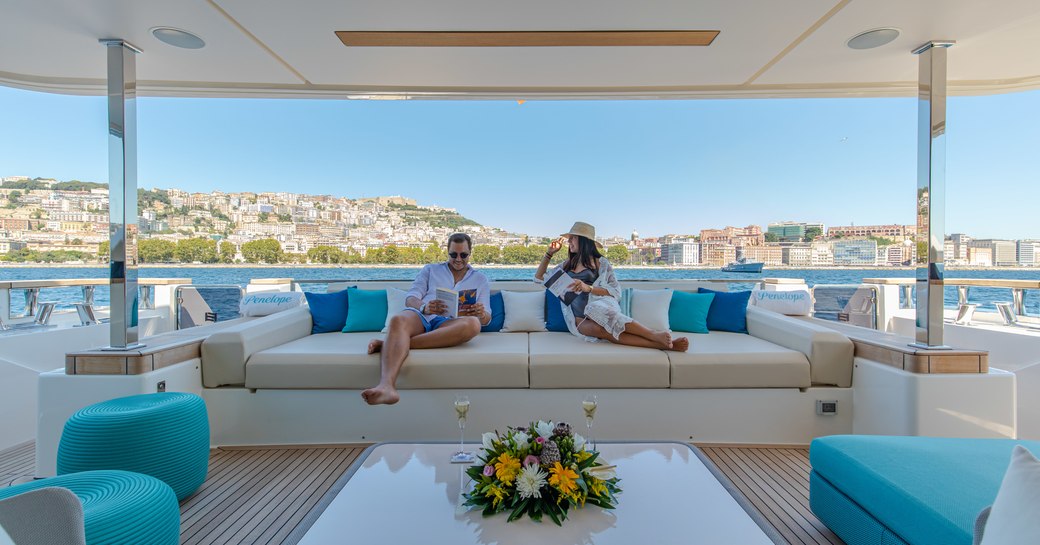 charter guests relax on the deck of custom line yacht penelope