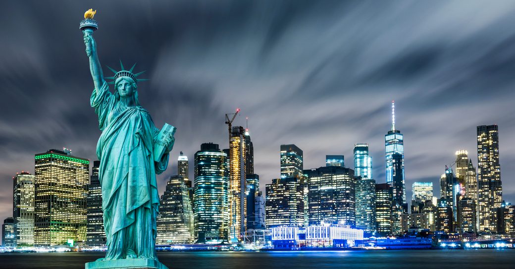 Statue of Liberty and New York skyline at night