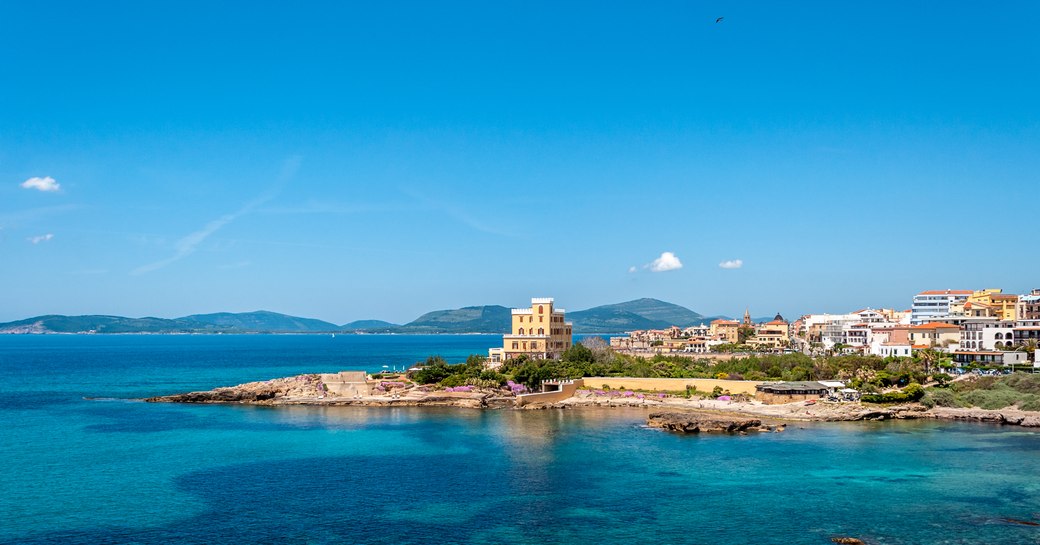 Seascape of Alghero, with old battlements by the sea