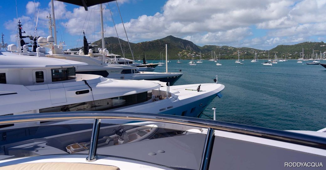 Bows of super yacht charters berthed in Antigua marina