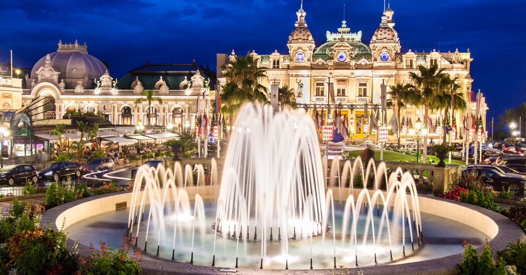 Monaco at night glistening lights and fountain