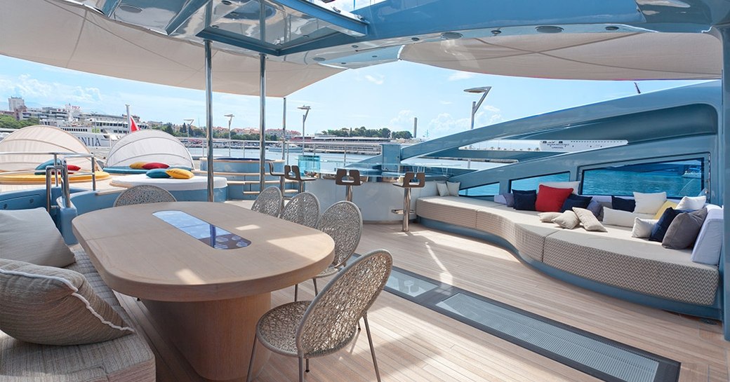 Alfresco dining area and Jacuzzi beyond on flybridge of motor yacht Philmi