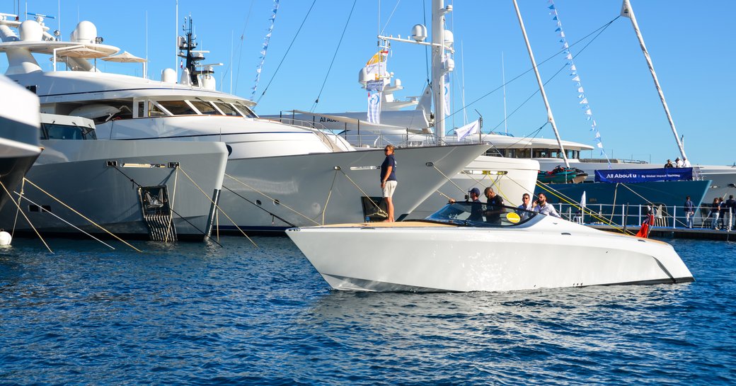 monaco yacht show tender lined up alongside luxury megayacht