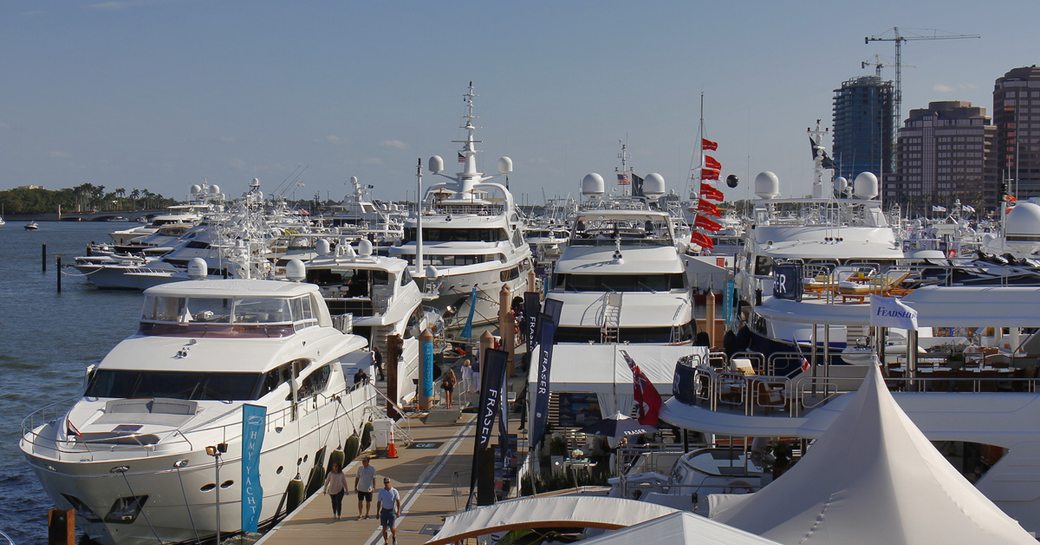 People on boardwalks alongside superyachts at Palm Beach Boat Show