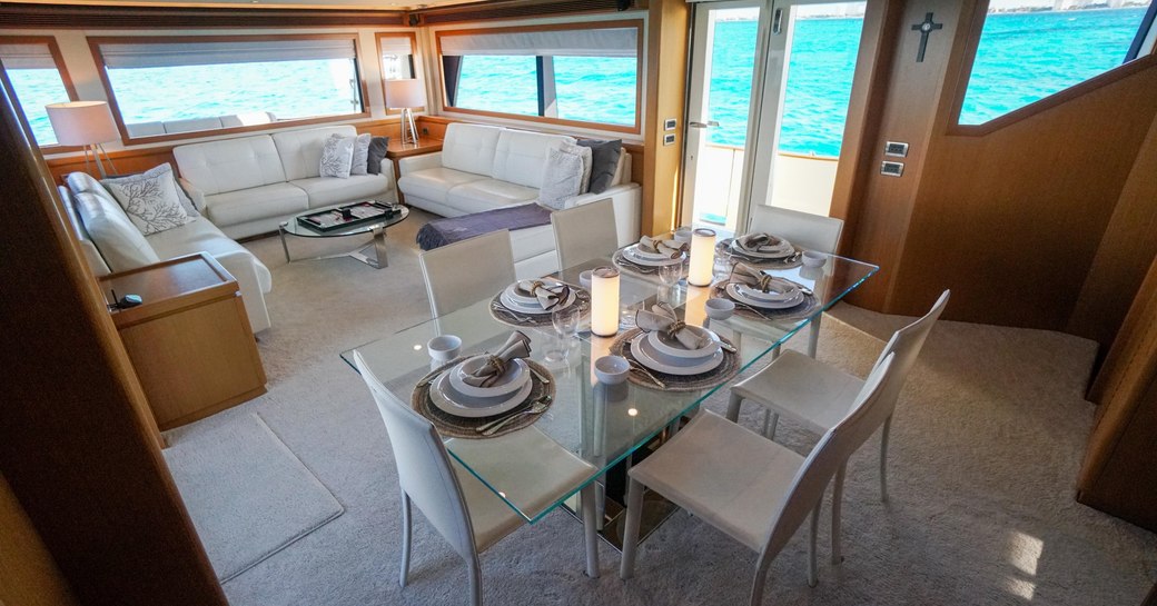 the airy and homely salon of luxury charter yacht NOMADA with wide open windows and sumptuous natural light 