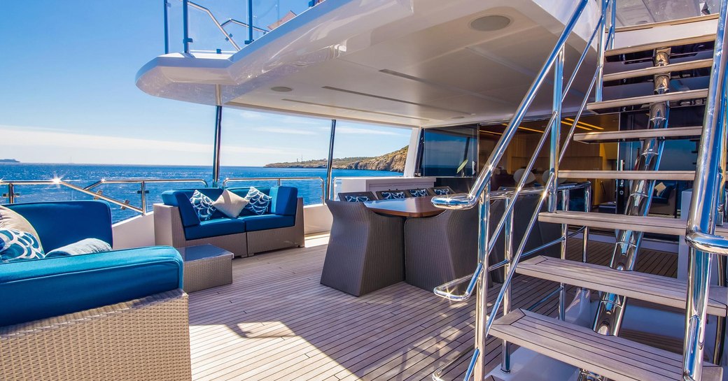 Seating and dining area on the aft deck of luxury yacht LULU