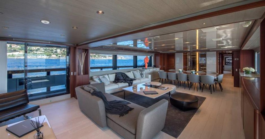 luxury yacht x main salon with sofa seating and dining table