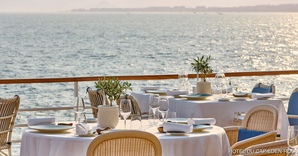 View of tables at Louroc Restaurant overlooking sea
