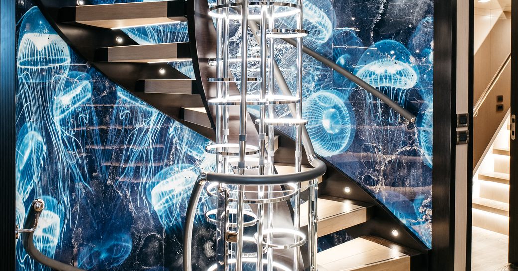 Decorative spiral staircase onboard charter yacht HEEUS