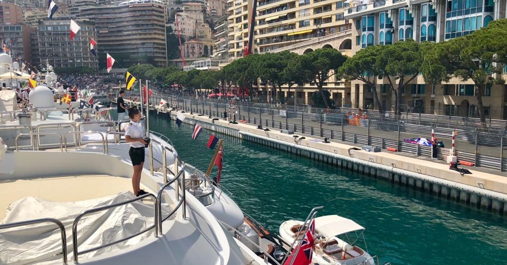 A yacht stewardess looking across the Monaco Grand Prix circuit